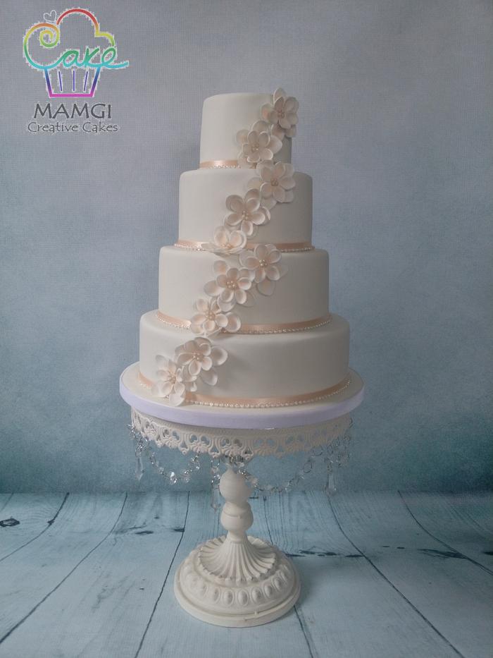 Peach tone floral wedding cake