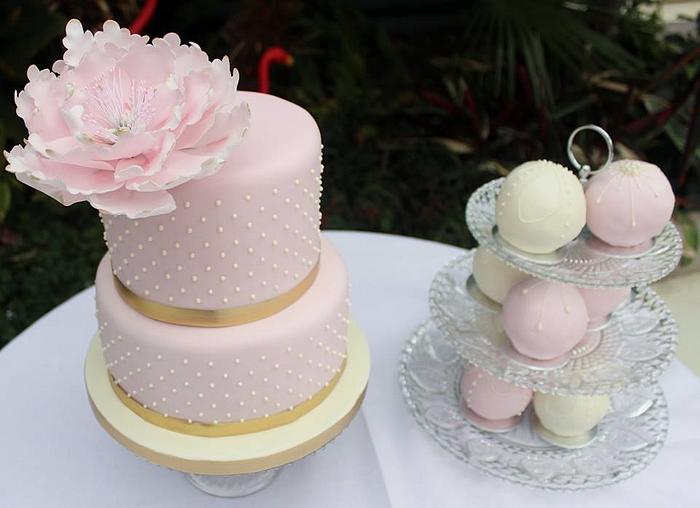 Vintage spotty wedding cake with small temari cakes and a large open peony.
