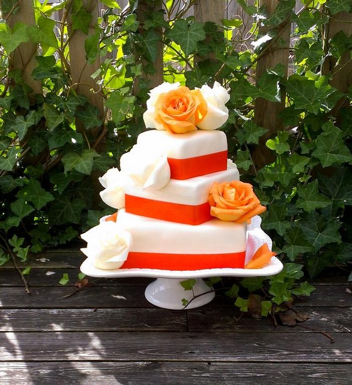 tangerine wedding cake with fresh roses