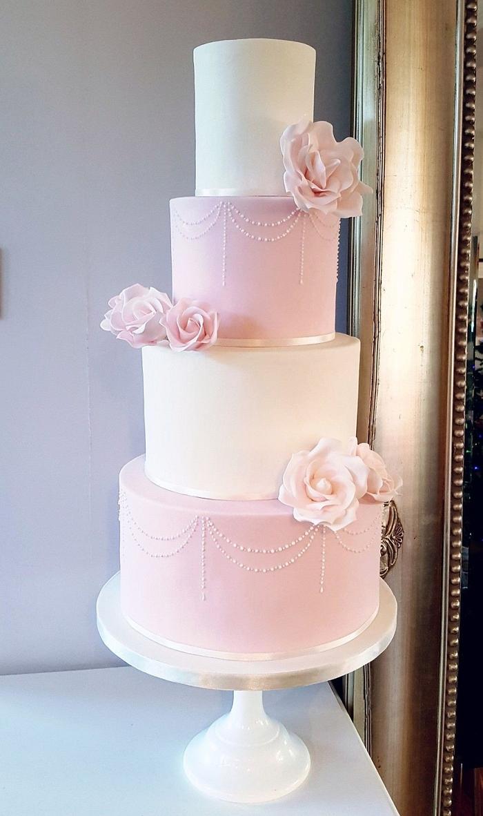 Blush pink and ivory rose wedding cake