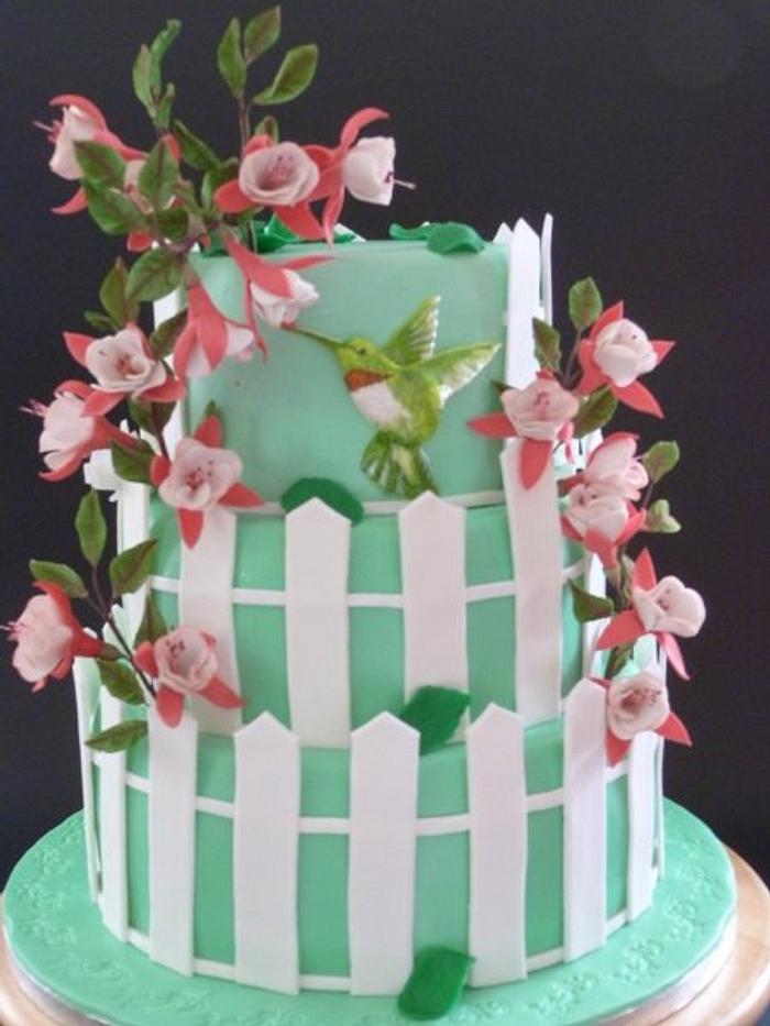 colibri cake with fuschia flowers