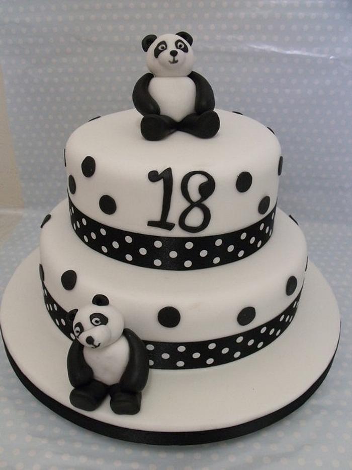 Premium AI Image | a black and white panda bear with a birthday cake