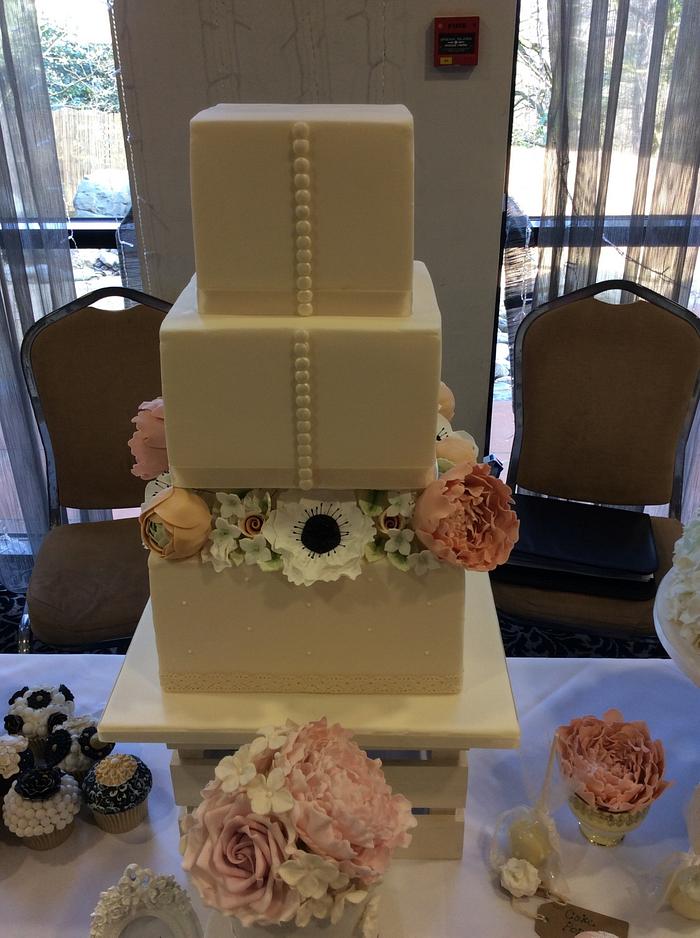 Anemone, peony and ranunculus wedding cake and cupcakes