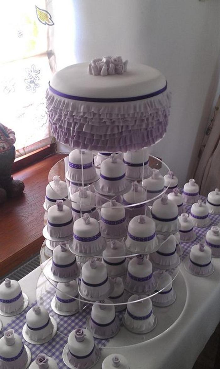Rainbow cake with lilac Ombre frills and 70 - 2" matching mini cakes 