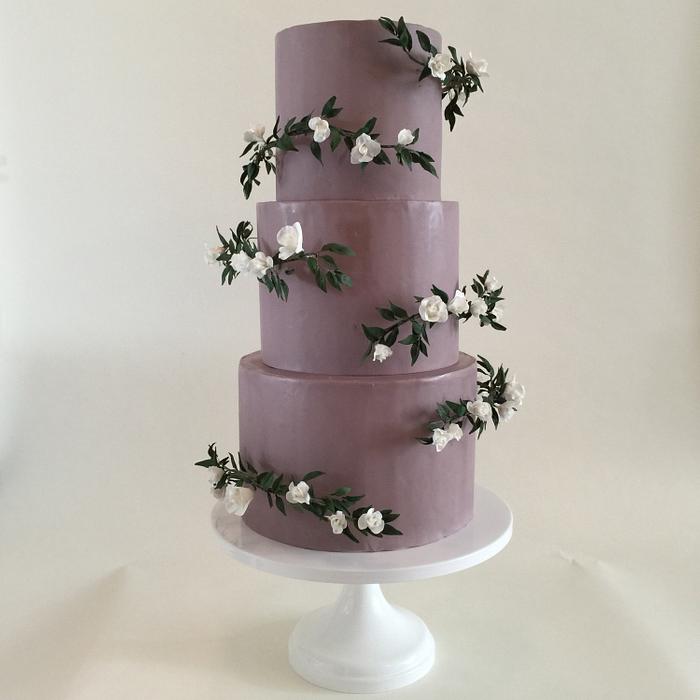Purple with sugar gardenia and ruscus half halos