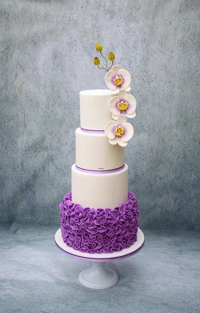 White / Purple Wedding Cake with Ruffles and Orchids
