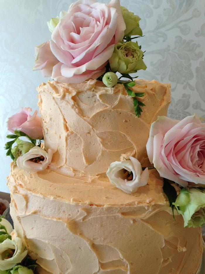 Gorgeous coral cream and fresh flower wedding cake