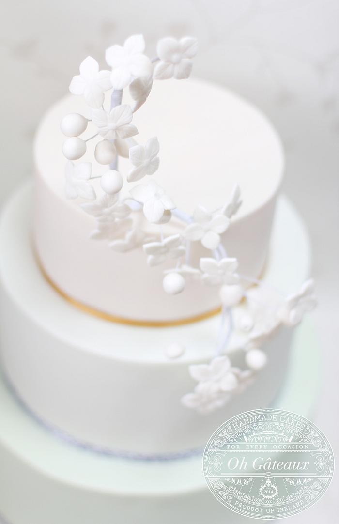Three tier ombre cake with delicate stylised flowers to match a bridal headdress.