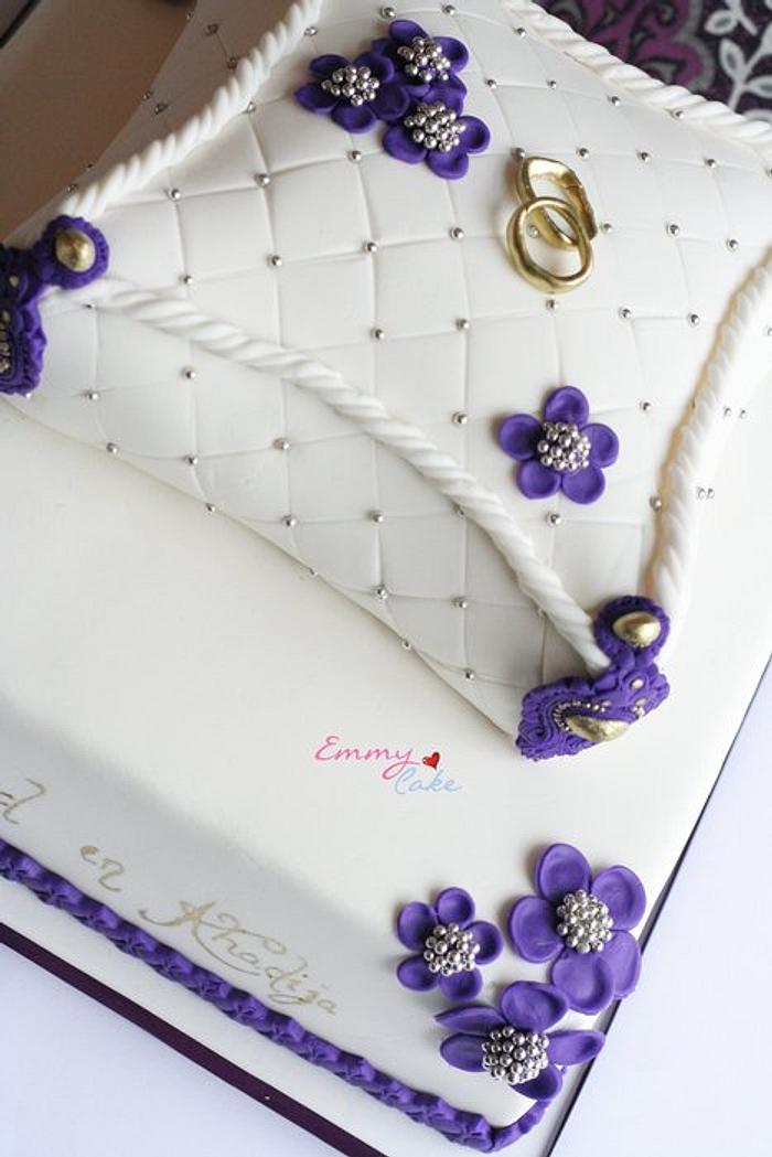 White cushion engagement cake with touch of purple, silver and gold