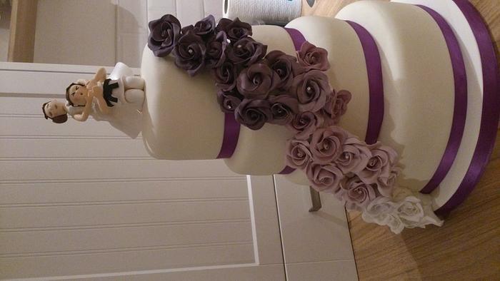 four tiered wedding cake with purple roses and bride and groom handmade topper (with karate theme) x