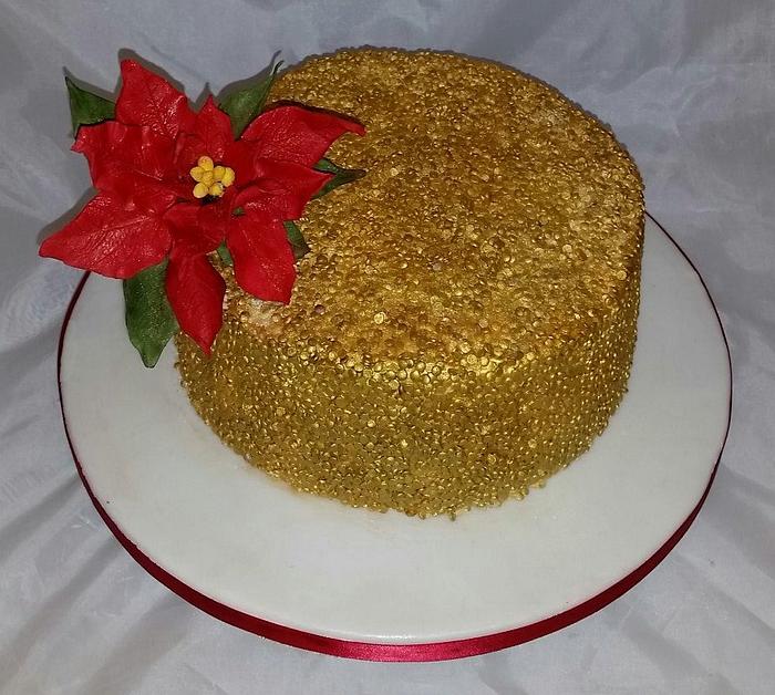 Gold sequin Christmas cake with poinsetta 