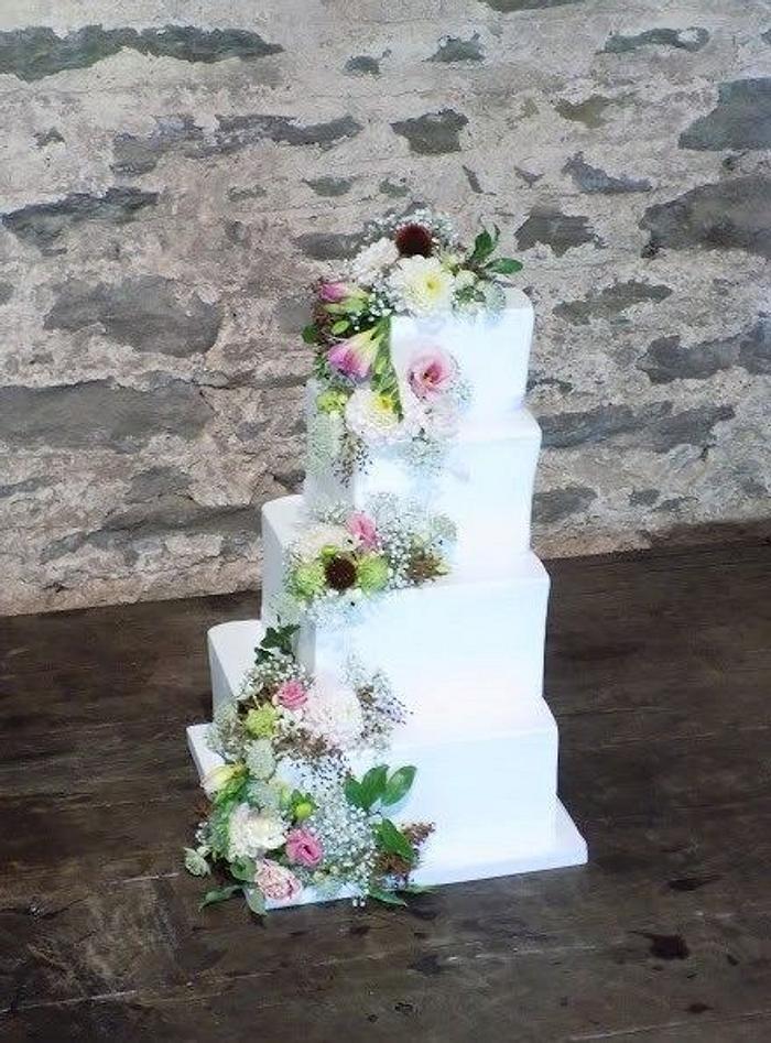 Stepped square wedding cake with Fresh blooms