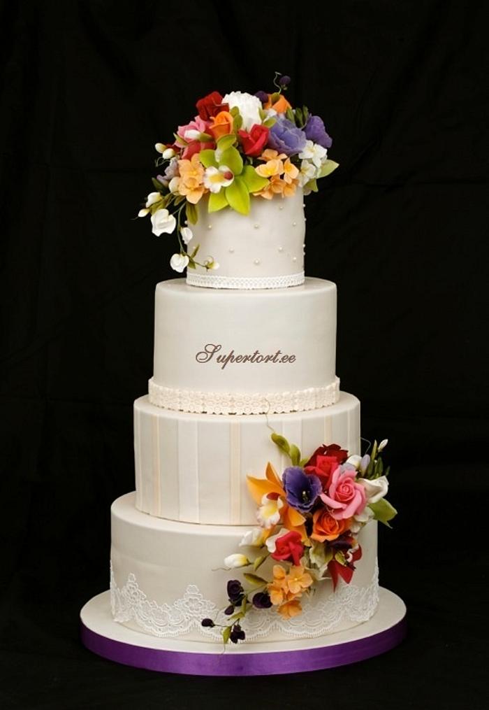 Ivory cake and colorful bouquets