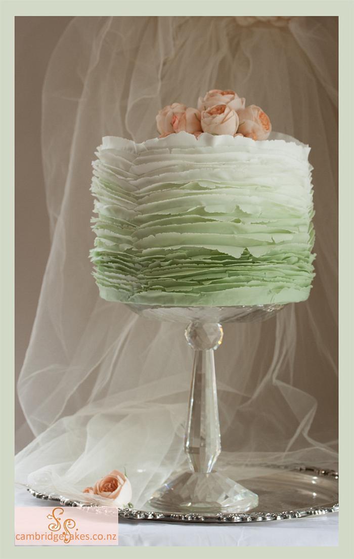 Sp.Iced green ombre frills with peach roses.