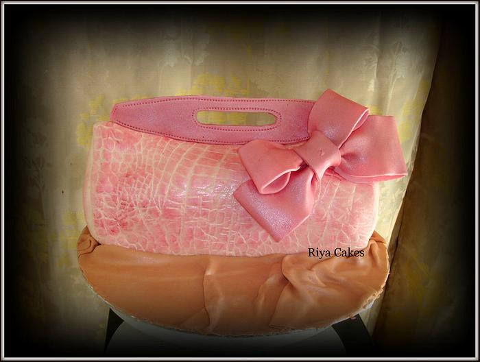 Pink designer clutch cake