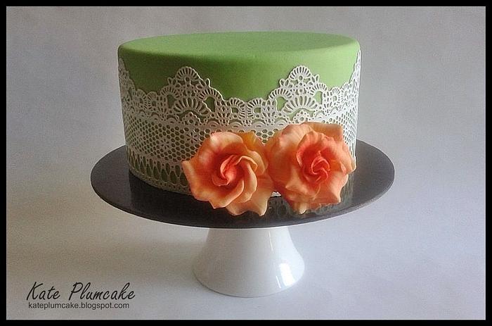 Green cake with laces and orange roses