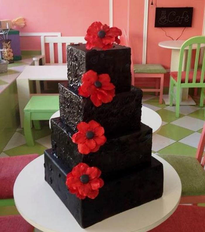 Black cake with red anemonies