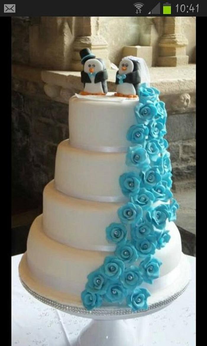 White 4 Tier Wedding Cake With Blue Roses