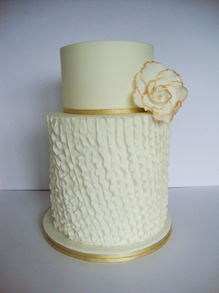 Diagonal ruffles with a large flower etched in gold.
