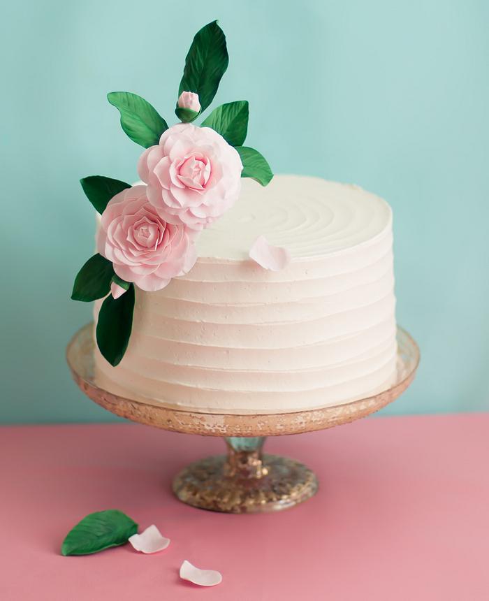 Buttercream cake decorated with sugar camellias