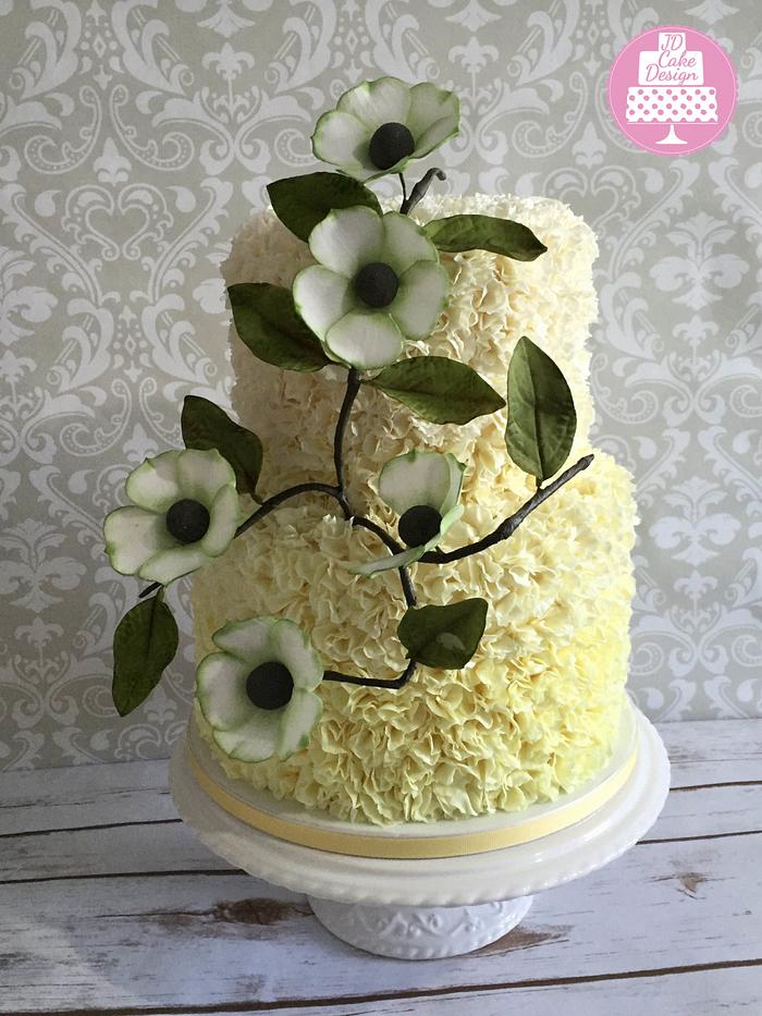 Lemon ombre ruffle cake with branch flowers
