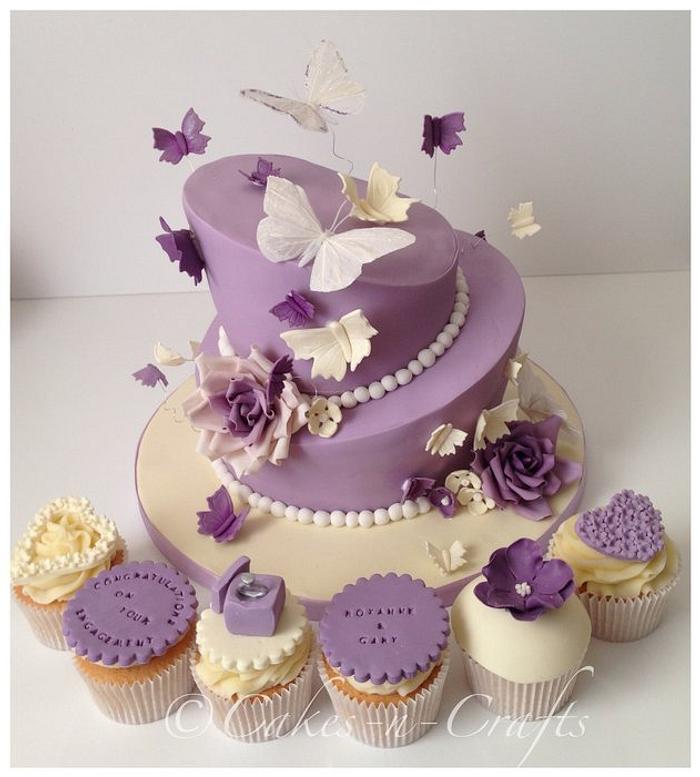 2 tier topsy turvy engagement cake and cupcakes