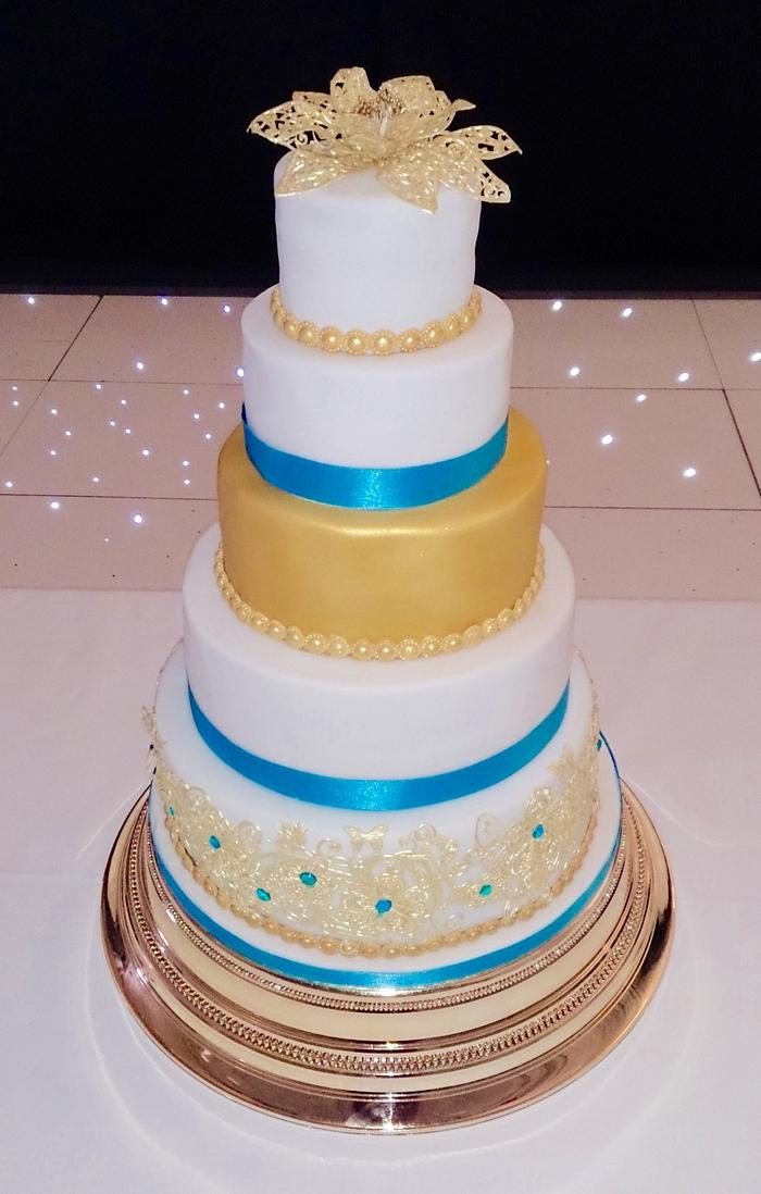 Gold lace and peacock blue wedding cake