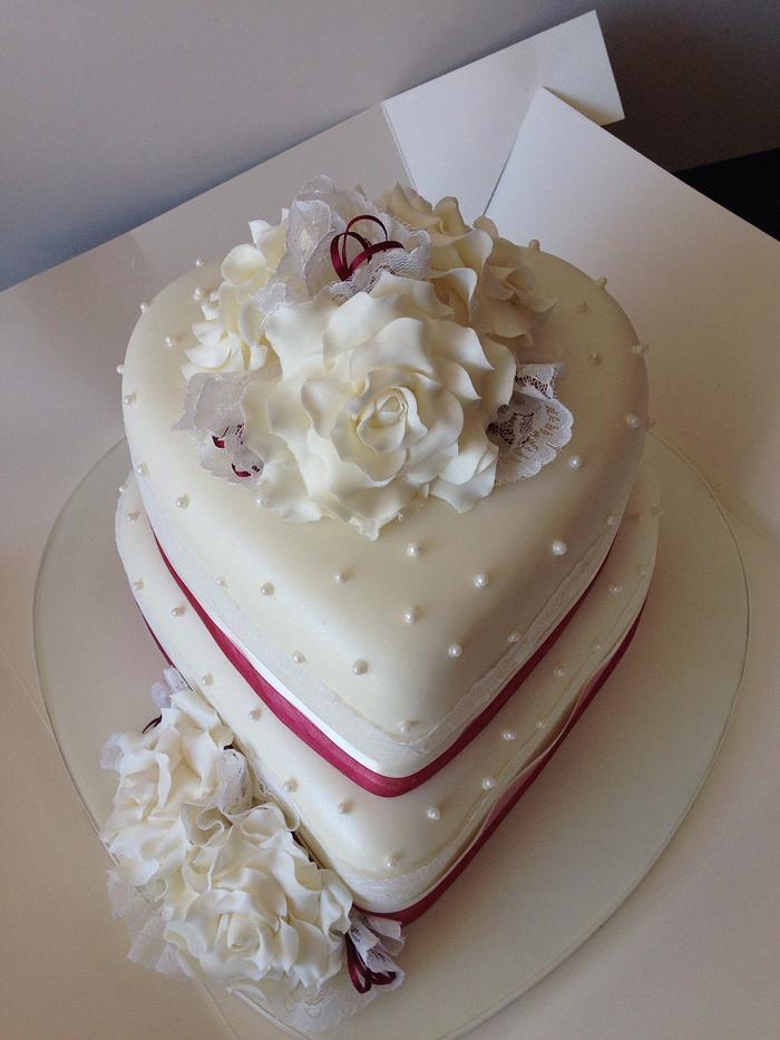 Heart shaped white two tier wedding cake at beach wedding | Flickr