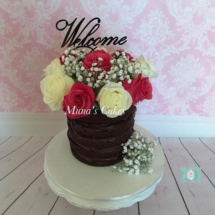 Chocolate naked cake with fresh flowers 