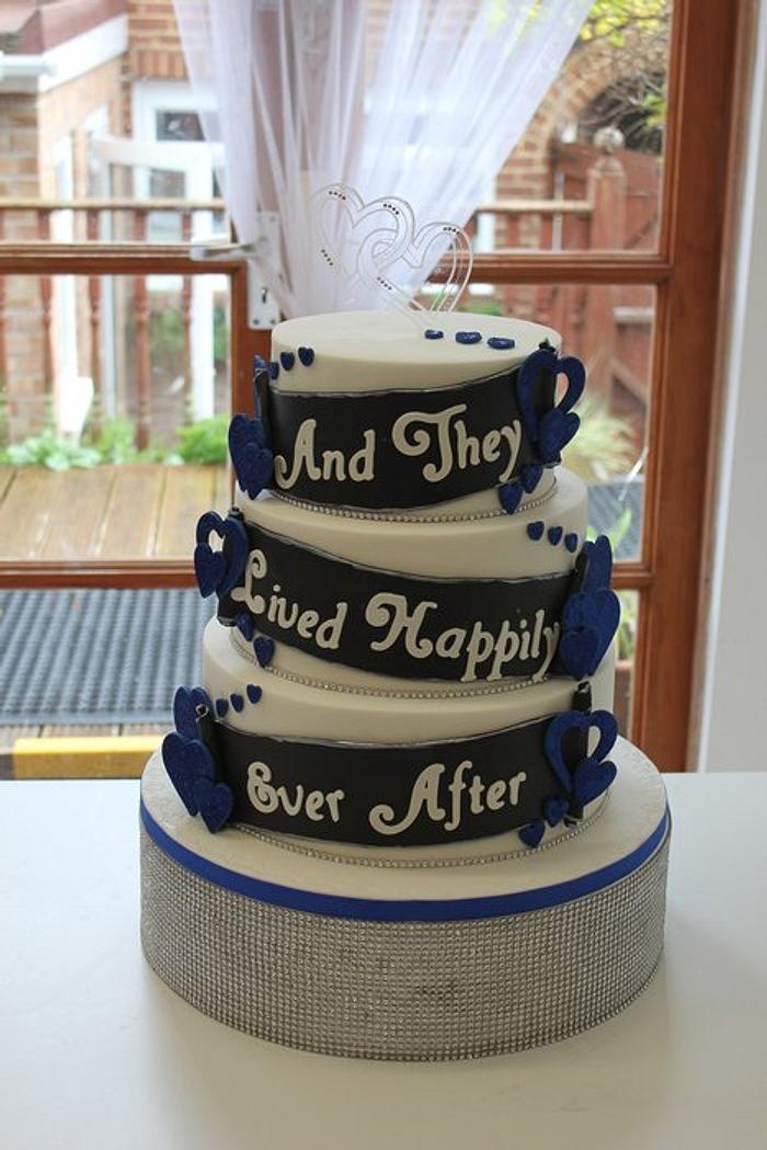 Royal blue, black and white " and they lived happily ever after" wedding cake