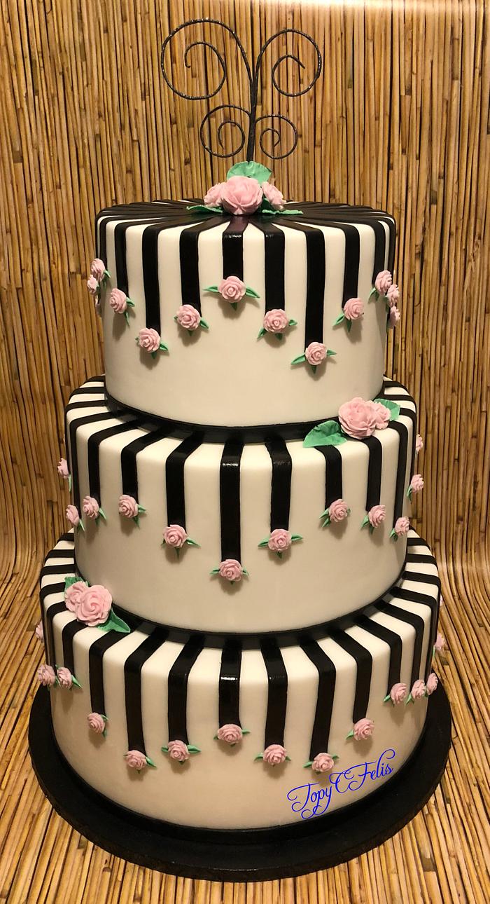 Wedding cake with black strips and pink roses