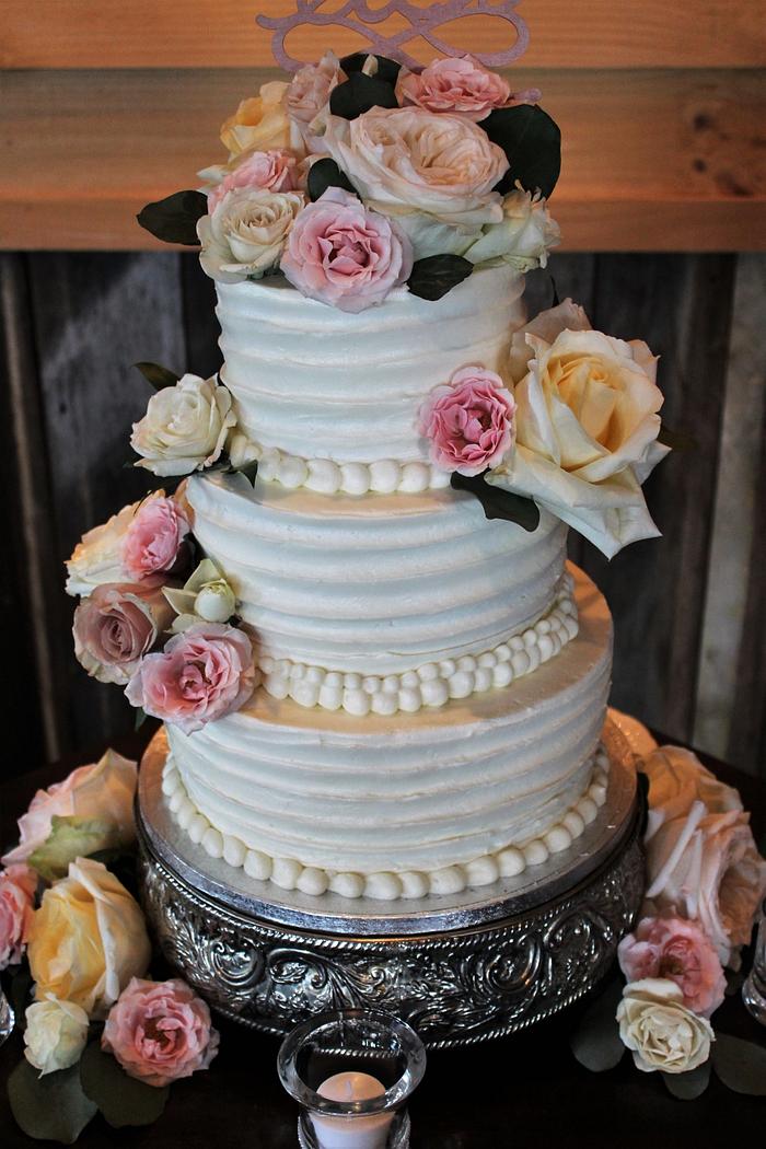 Buttercream wedding cake fresh flowers
