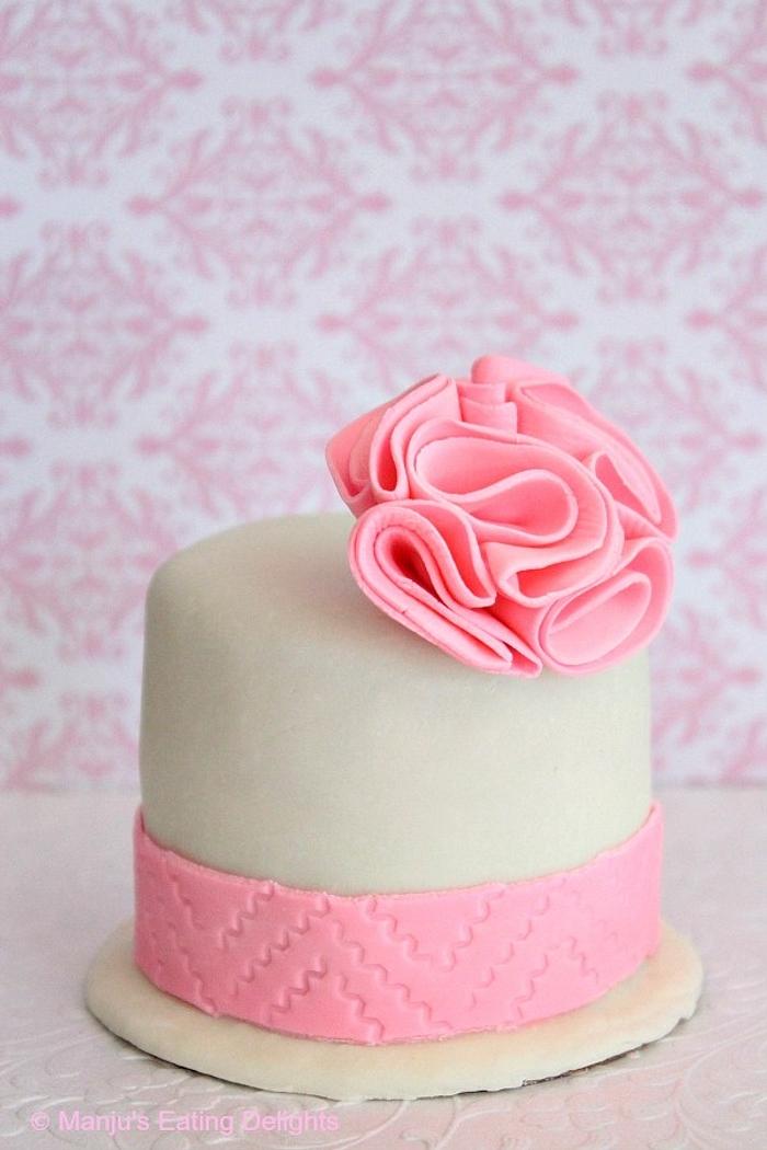 Mini Cake with Pink Pompom flower and fondant border