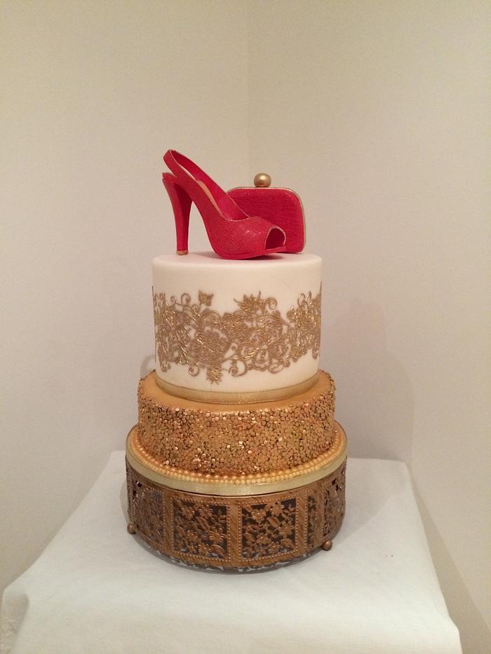 Red crocodile effect shoe and bag with golden lace and sequin cakes