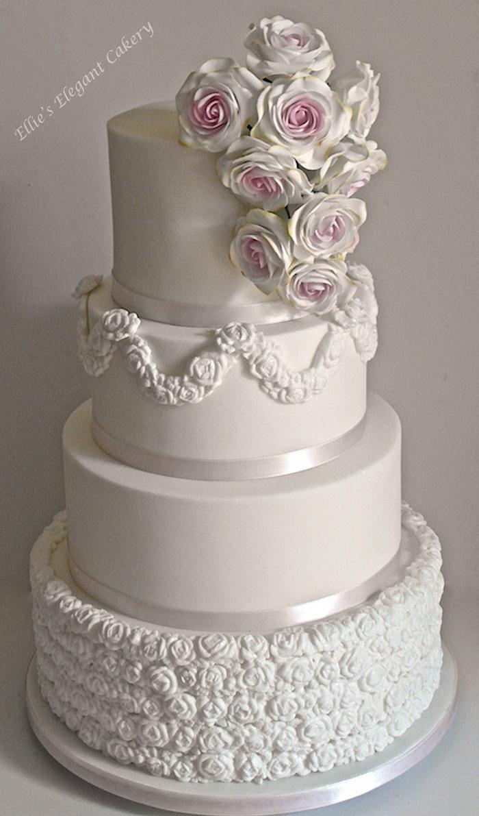 Elegant tumbling rose wedding cake