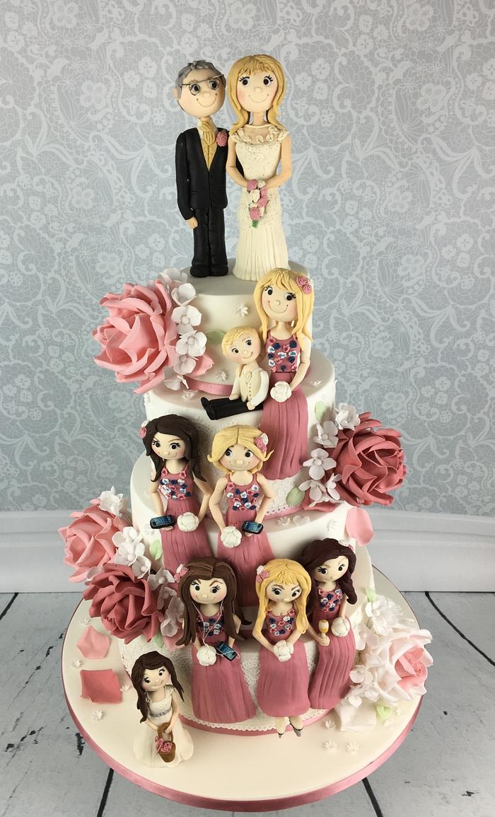 Dusky pink wedding cake with 10 sugar figures