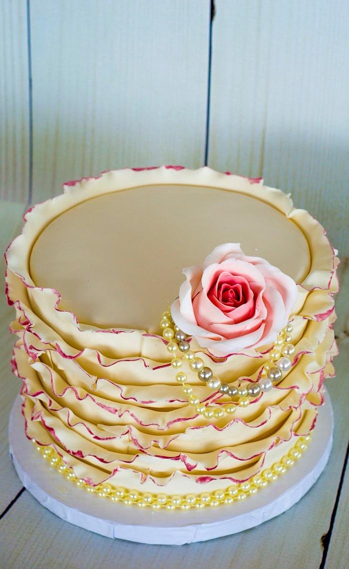 Ivory and coral ruffled wedding cake 