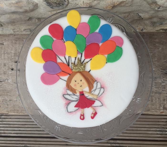 Fairy holding balloons cake
