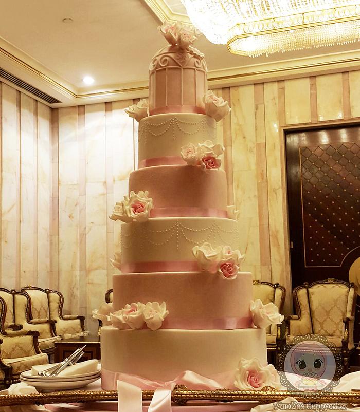 Pink and white bird cage wedding cake