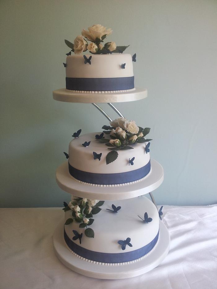 Ivory Roses and Navy butterflies Wedding Cake