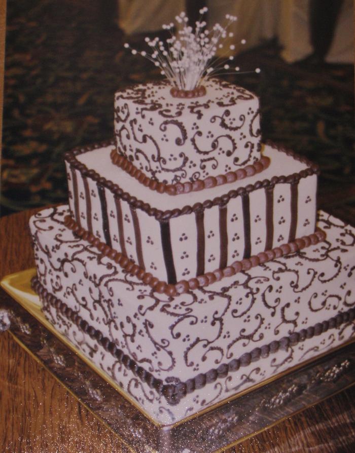 Brown buttercream scrollwork wedding cake