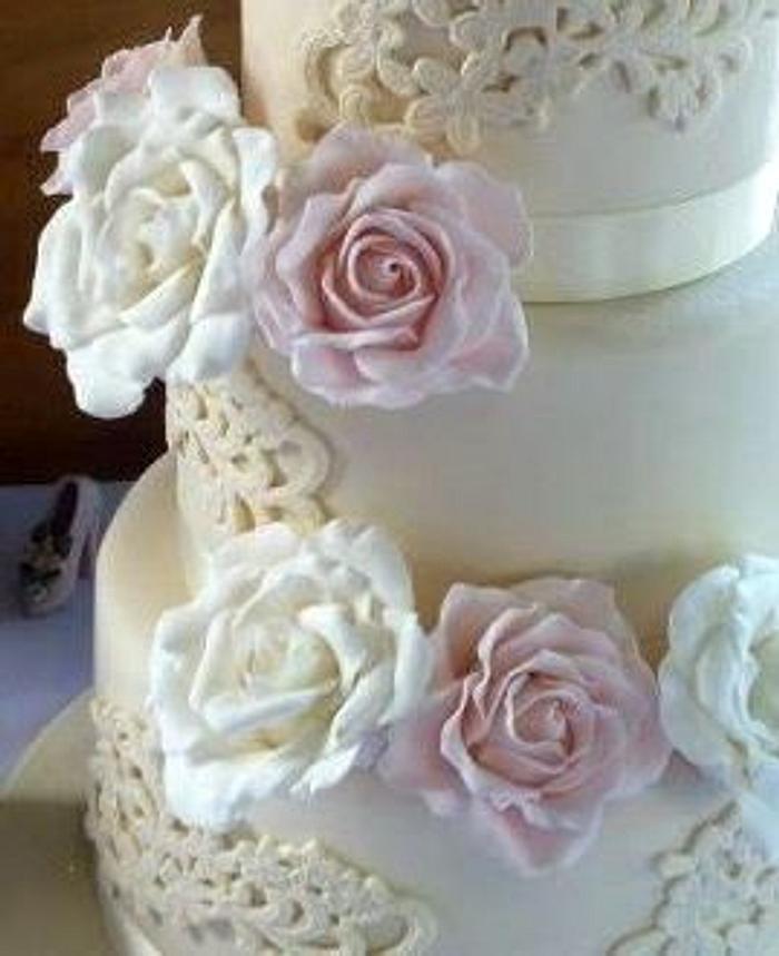 Three tier hand cut lace and sugarpaste rose cream wedding