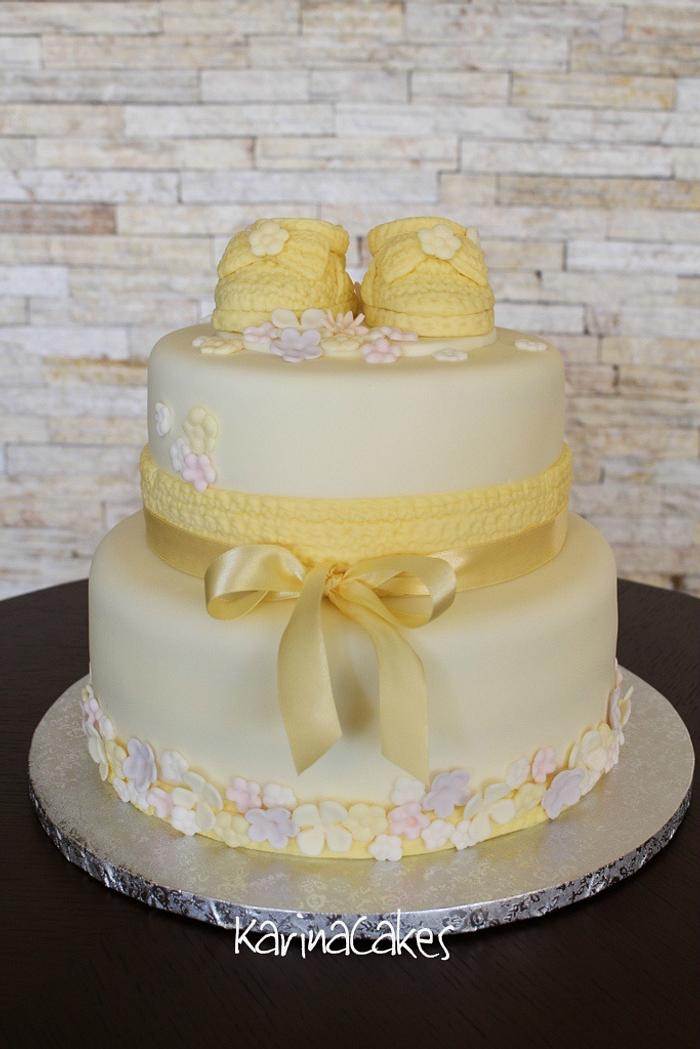 Christening cake with yellow shoes