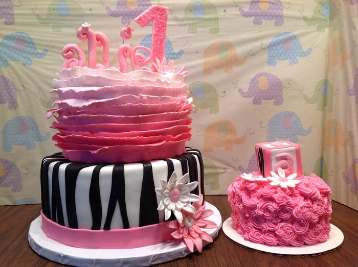 Pink ruffled-zebra striped first birthday cake. 
