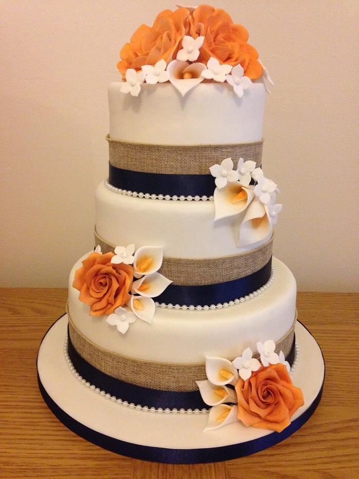 Hessian, navy and orange roses and call lillies