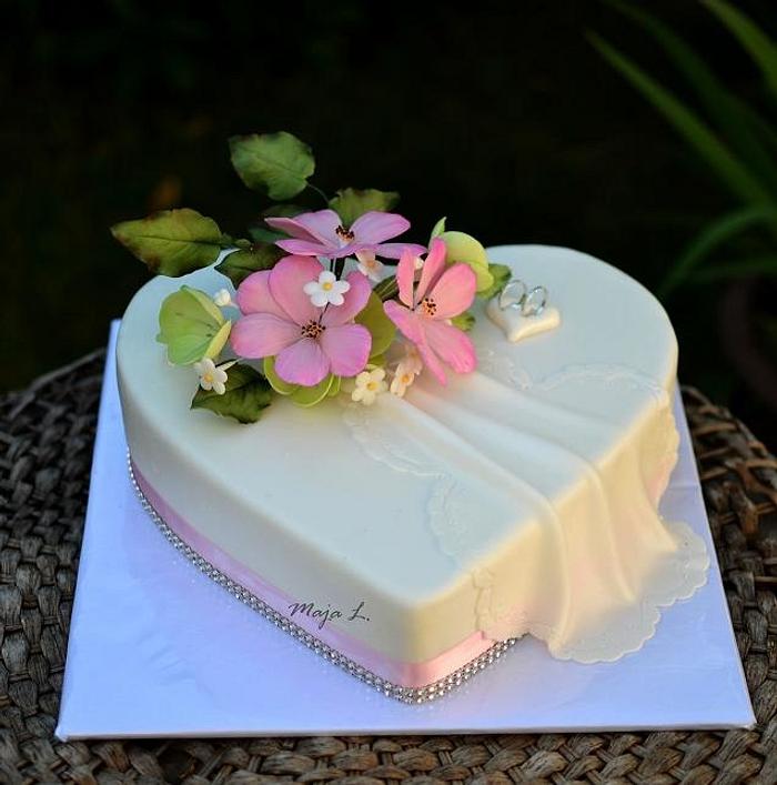 Heart shaped wedding cake with cosmos flowers