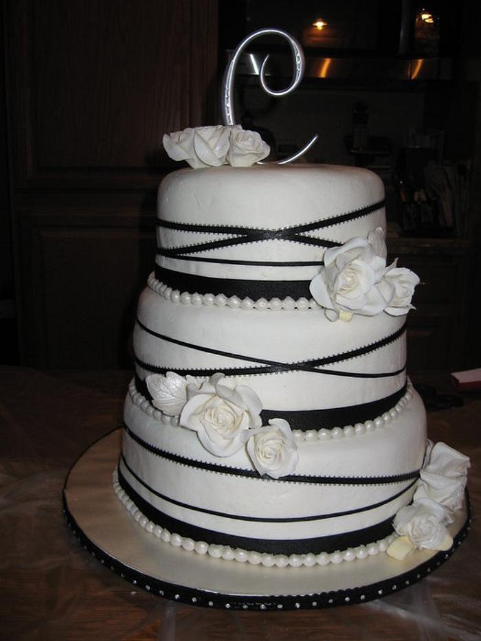 Ivory and black ribbon cake with gumpaste roses
