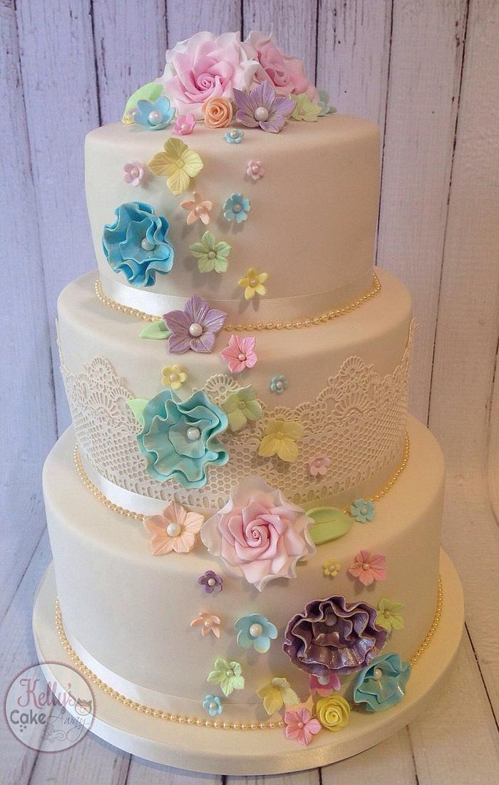 Pastel rainbow flower cascade wedding cake 