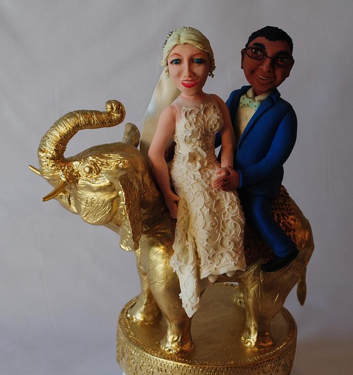 Bride and groom on a golden elephant