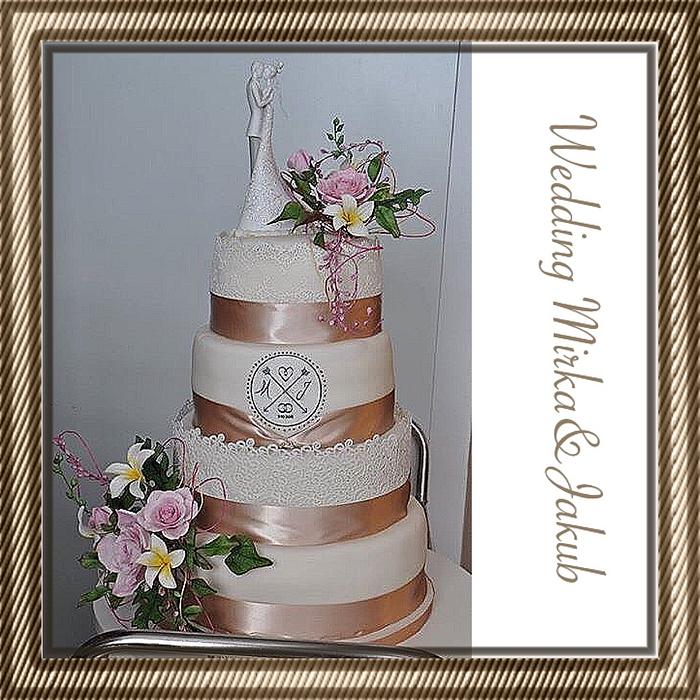 Wedding cake with roses, frangipany, monstera, berries...
